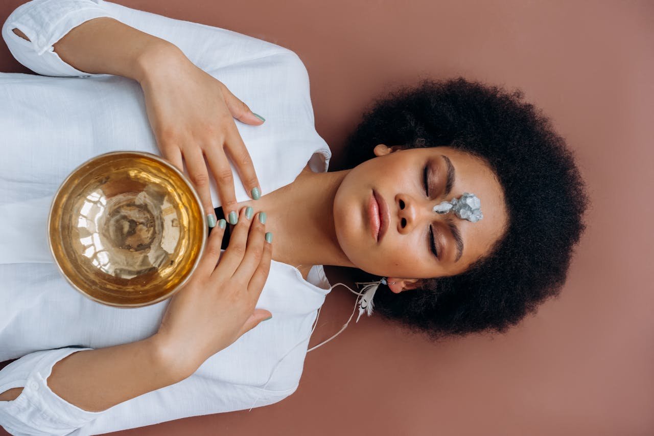 Tibetan Singing Bowl on a Womans Chest Lying on the Ground